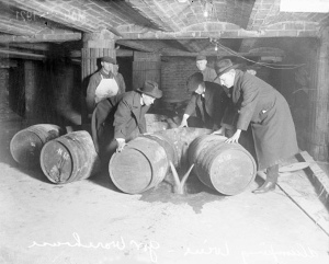 Photograph of prohibition agents destroying barrels of alcohol, circa 1921